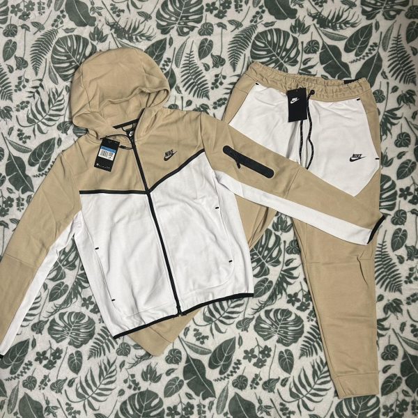 Nike cream and white tech suit.